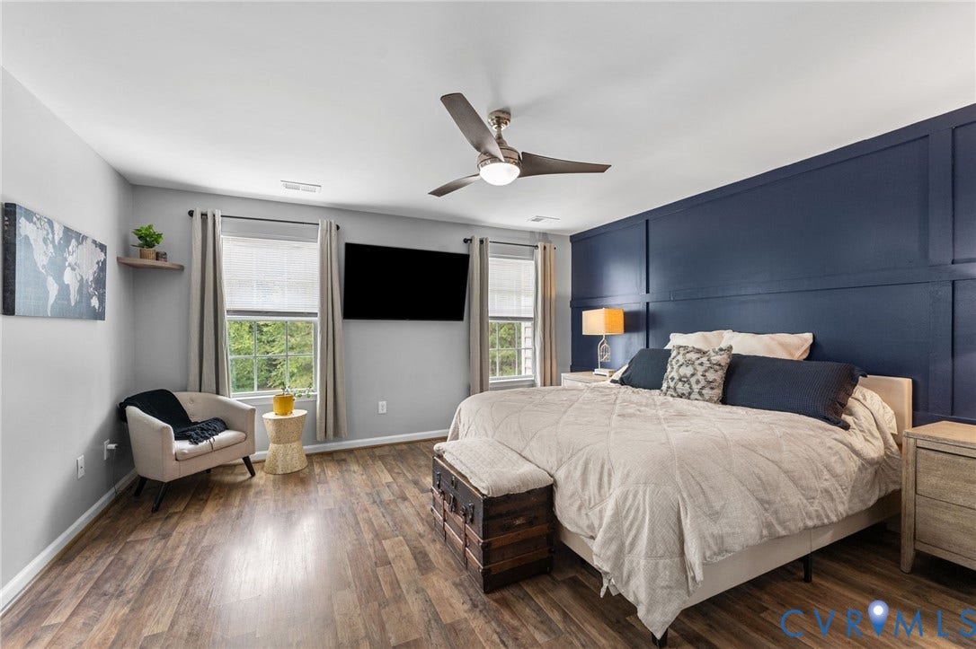 5112 Weatherby Drive, Chester, VA 23831 Wood-finish flooring, accent wall with paneling, ceiling fan with integrated lighting, two windows with blinds, and recessed lighting