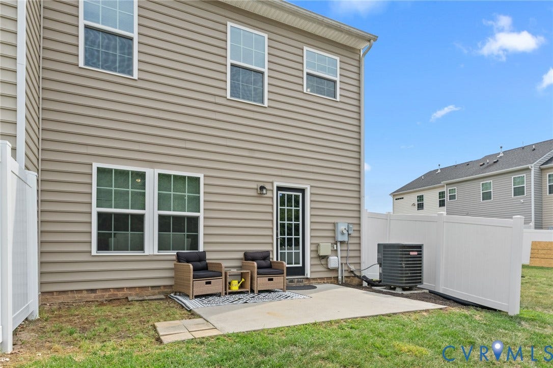 5112 Weatherby Drive, Chester, VA 23831 Private concrete patio with a white vinyl privacy fence and a rear access door