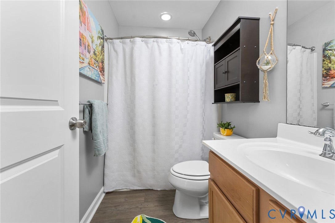 5112 Weatherby Drive, Chester, VA 23831 Recessed lighting, wood-finish flooring, built-in vanity with integrated sink, chrome faucet, and wall-mounted storage cabinet