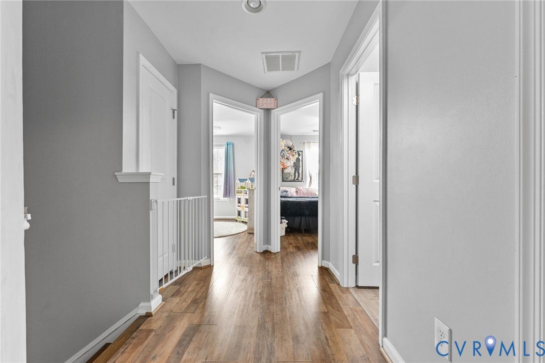 5112 Weatherby Drive, Chester, VA 23831 Hallway featuring wood-finish flooring, light gray walls, and white trim