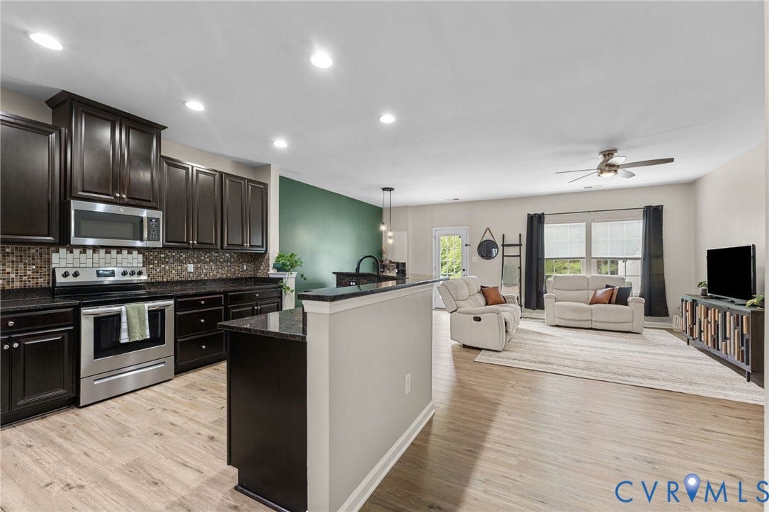 5112 Weatherby Drive, Chester, VA 23831 Open-concept living space featuring wood-finish flooring, dark wood cabinetry, stainless steel appliances, recessed lighting, and a ceiling fan
