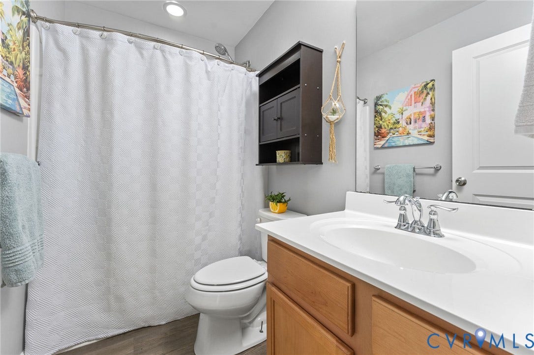 5112 Weatherby Drive, Chester, VA 23831 Full bathroom with a single vanity, wood-finish cabinetry, and chrome fixtures
