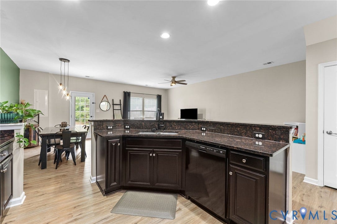 5112 Weatherby Drive, Chester, VA 23831 Kitchen featuring dark wood-finish cabinetry, dark speckled countertops, and wood-finish flooring
