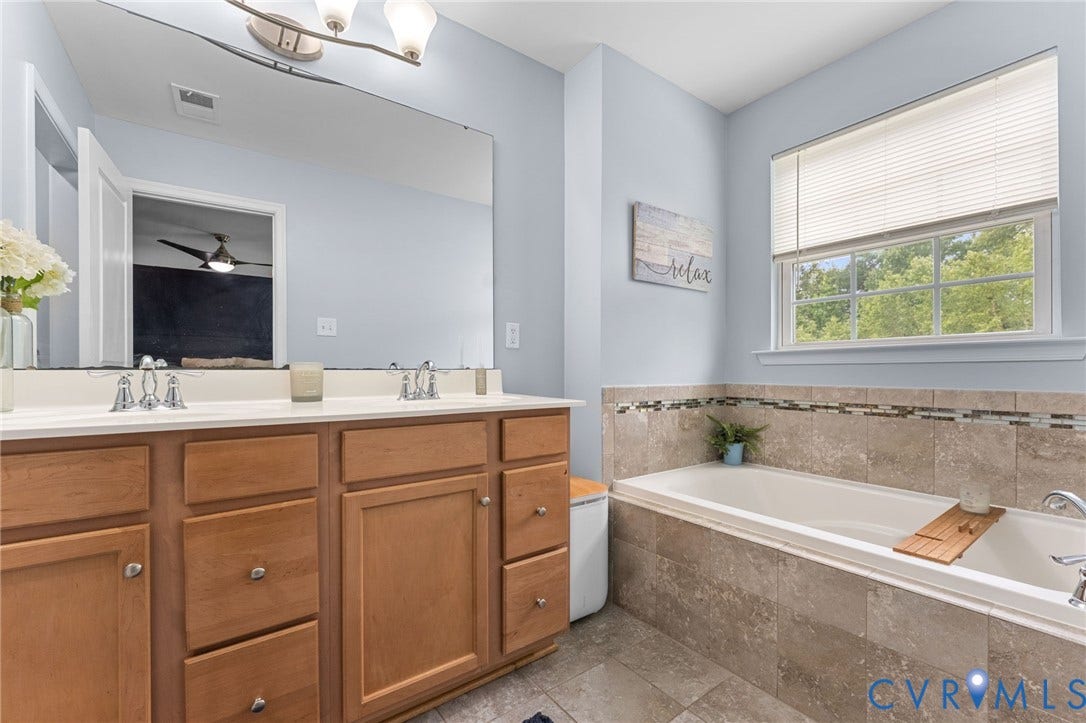5112 Weatherby Drive, Chester, VA 23831 Dual vanity with wood-finish cabinetry and chrome fixtures