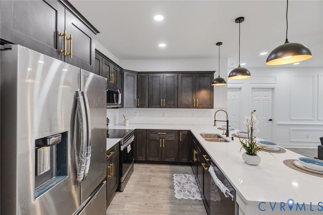 524 Cameron Street, Petersburg, VA 23803 Modern kitchen featuring dark wood cabinetry, stainless steel appliances, white countertops, and pendant lighting