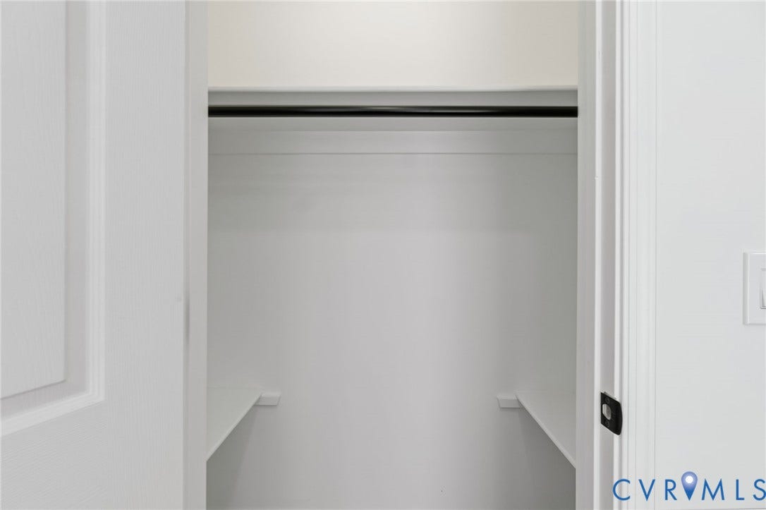 524 Cameron Street, Petersburg, VA 23803 Recessed closet with a black hanging rod and white shelving
