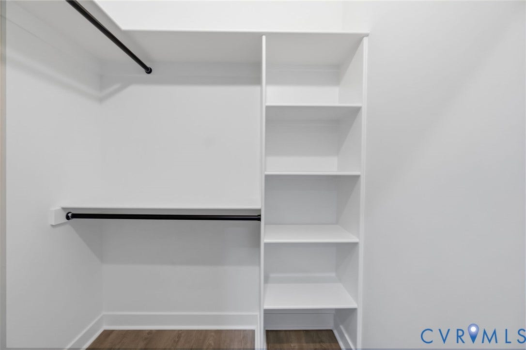 524 Cameron Street, Petersburg, VA 23803 Built-in closet system featuring multiple shelves, two hanging rods, and wood-finish flooring