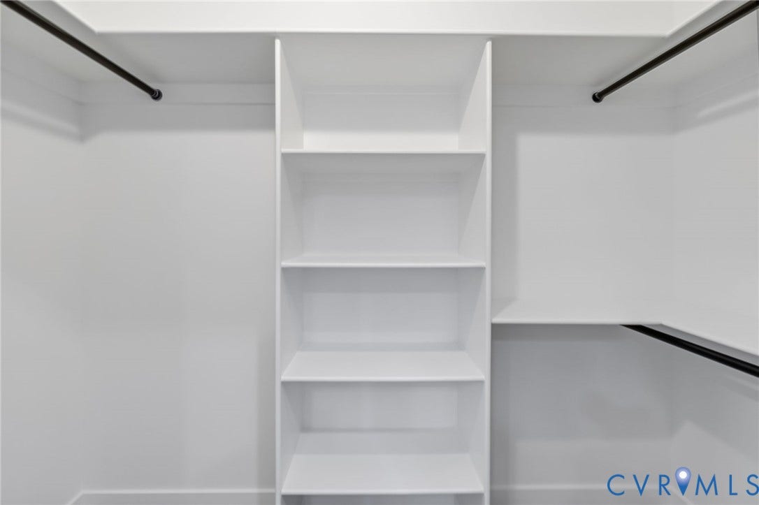 524 Cameron Street, Petersburg, VA 23803 Built-in white shelving, multiple clothing rods, and white painted walls