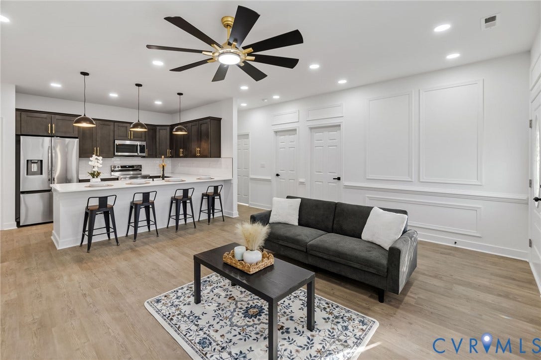 524 Cameron Street, Petersburg, VA 23803 Contemporary kitchen featuring stainless steel appliances, dark wood-finish cabinetry, and a white countertop island
