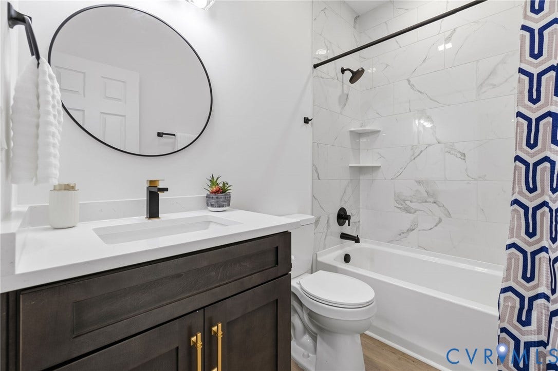 524 Cameron Street, Petersburg, VA 23803 Dark wood-finish vanity with gold-tone hardware, rectangular undermount sink, and a black-and-gold finish faucet