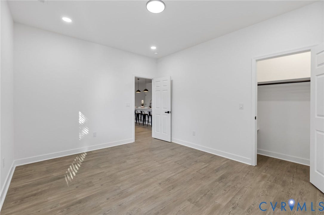 524 Cameron Street, Petersburg, VA 23803 Recessed lighting, wood-finish flooring, white walls, and a built-in closet with a hanging rod