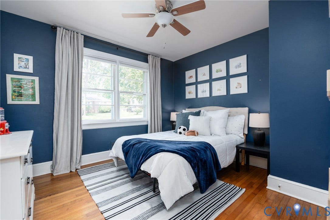 Hardwood flooring, painted walls, ceiling fan, and double-hung windows