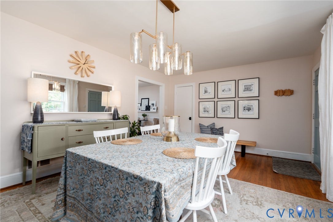Hardwood flooring, contemporary chandelier, crisp white trim, built-in shelving, and a decorative wall mirror