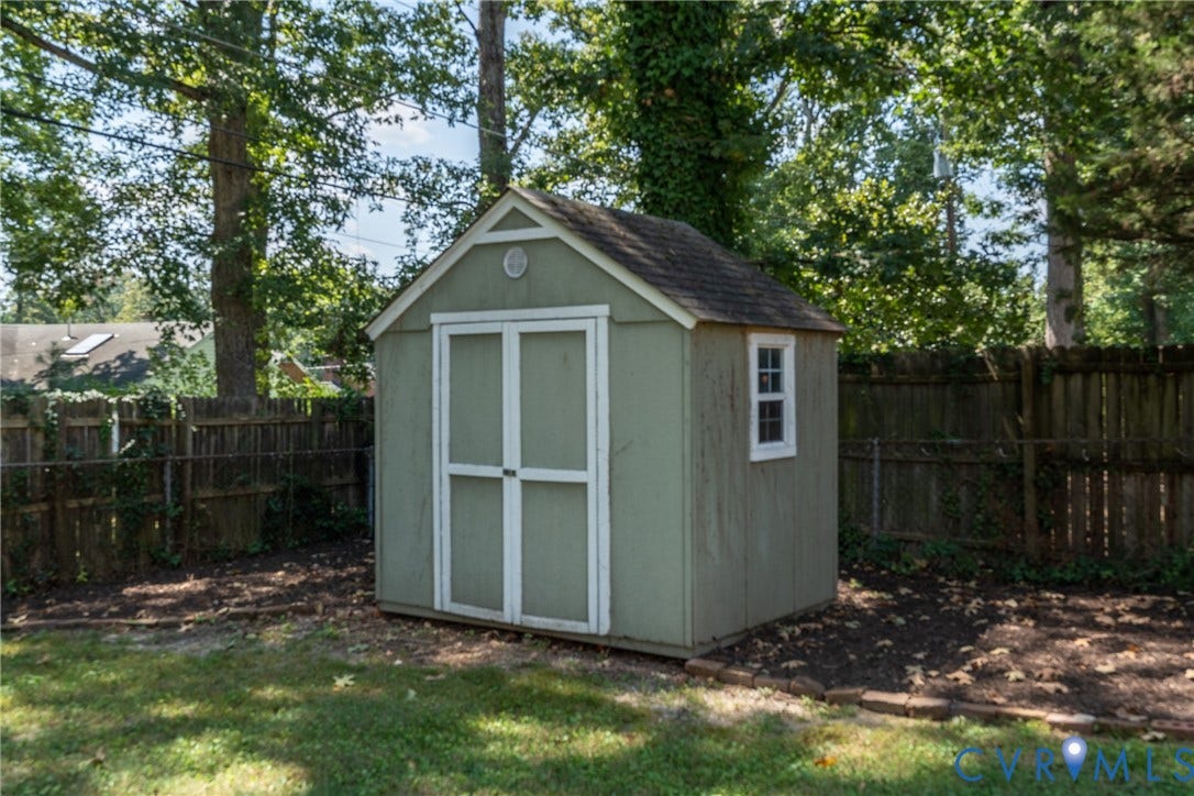 Detached storage shed with a gabled roof and painted siding