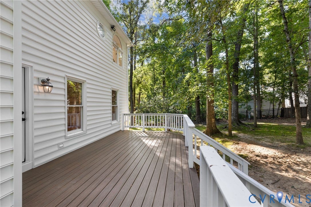Step through the new back door onto a spacious Trex deck overlooking the private, wooded backyard.