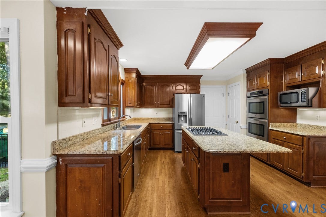 Stainless steel appliances and generous counter space complete this well-equipped kitchen.
