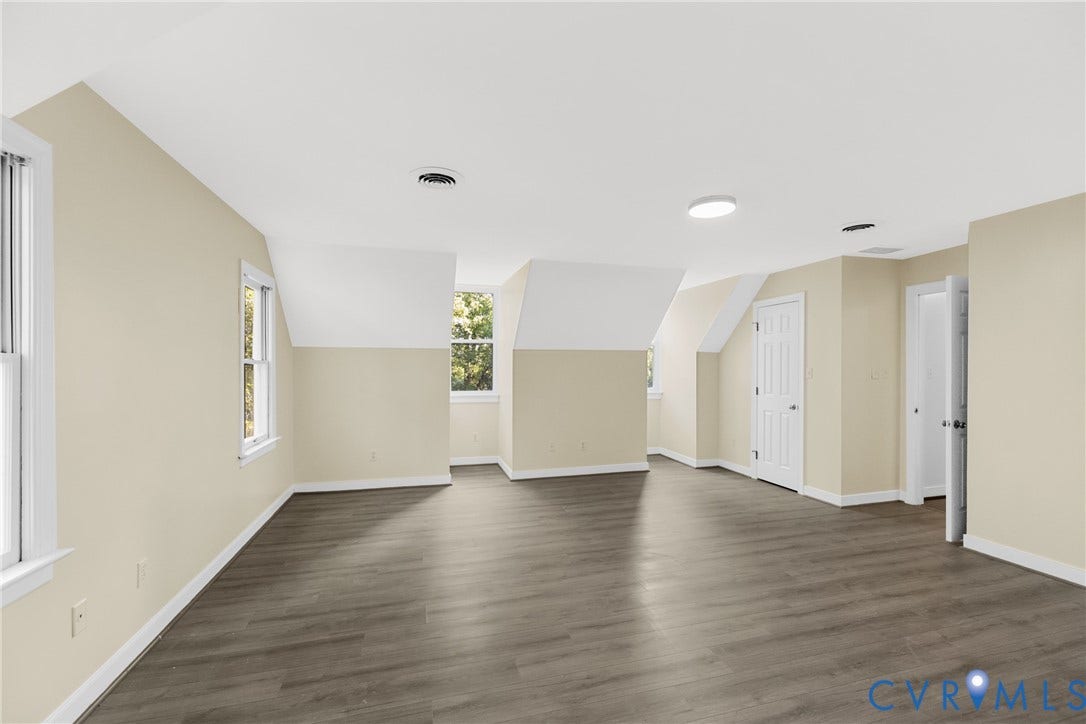 This bedroom offers ample space and easy access to a nearby bathroom.
