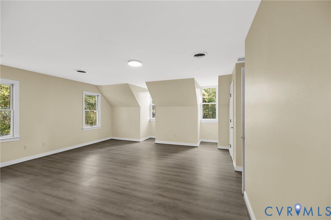 This bedroom offers ample space and easy access to a nearby bathroom.