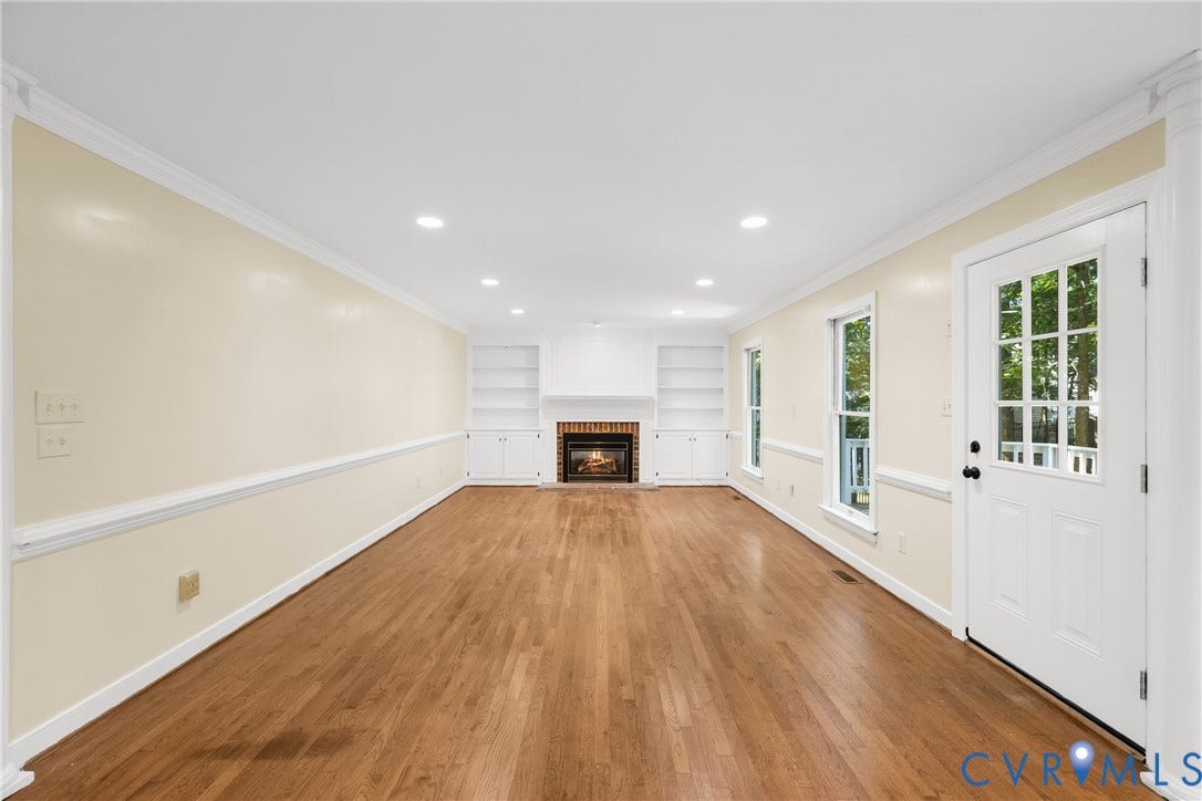 Crown molding and rich hardwood floors add polish to this spacious family gathering space.