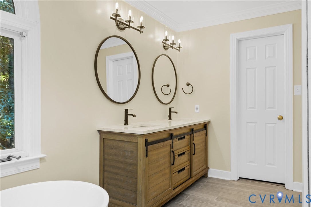 Dual vanities and statement mirrors complete the primary bath's upscale design.