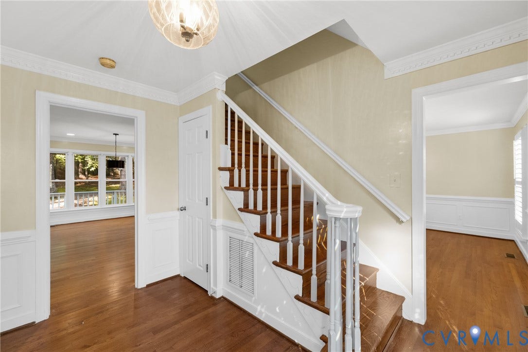 The foyer's staircase and hardwood floors set an elegant tone at the heart of the home.