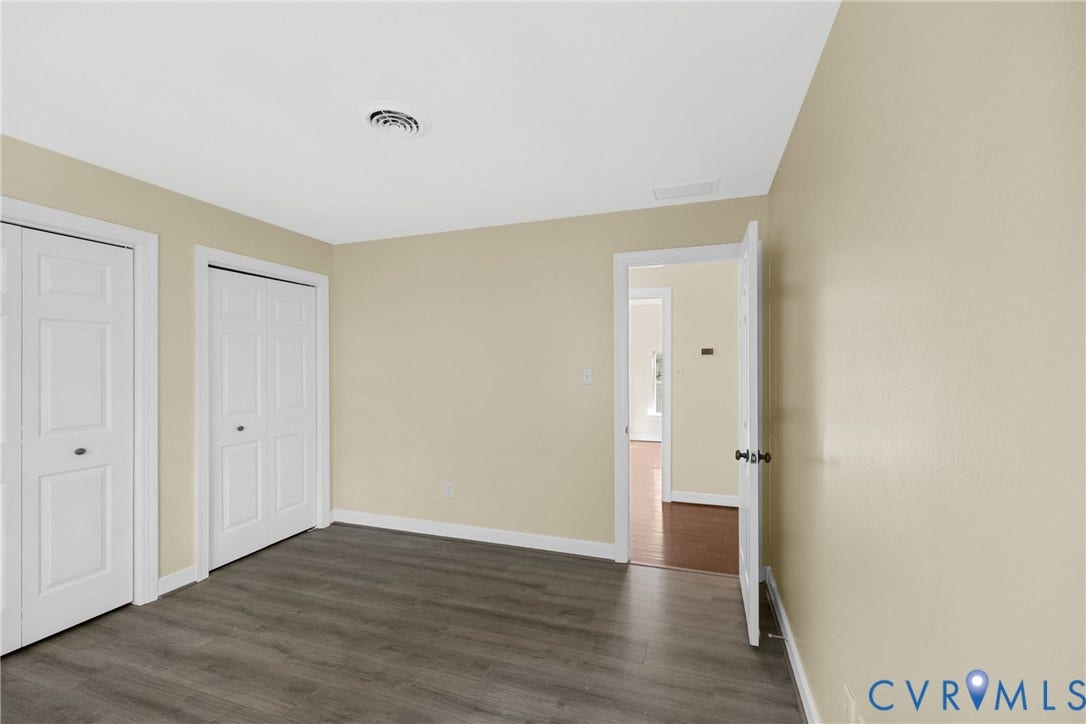 Double closets provide extra storage in this well-proportioned bedroom.
