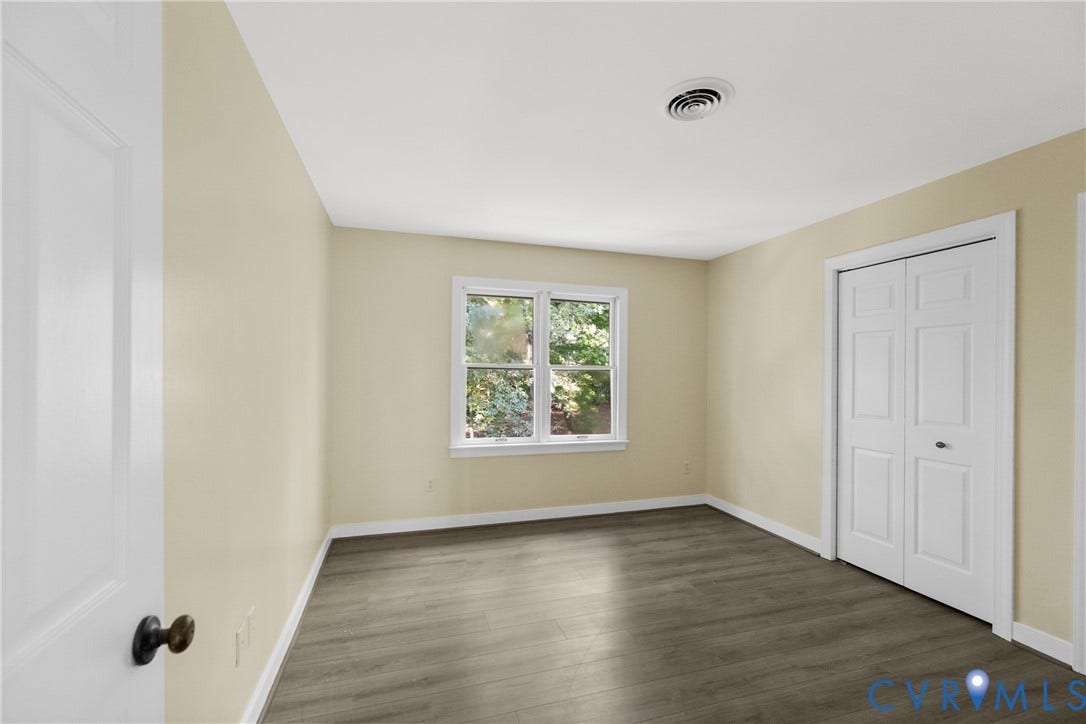 Double closets provide extra storage in this well-proportioned bedroom.