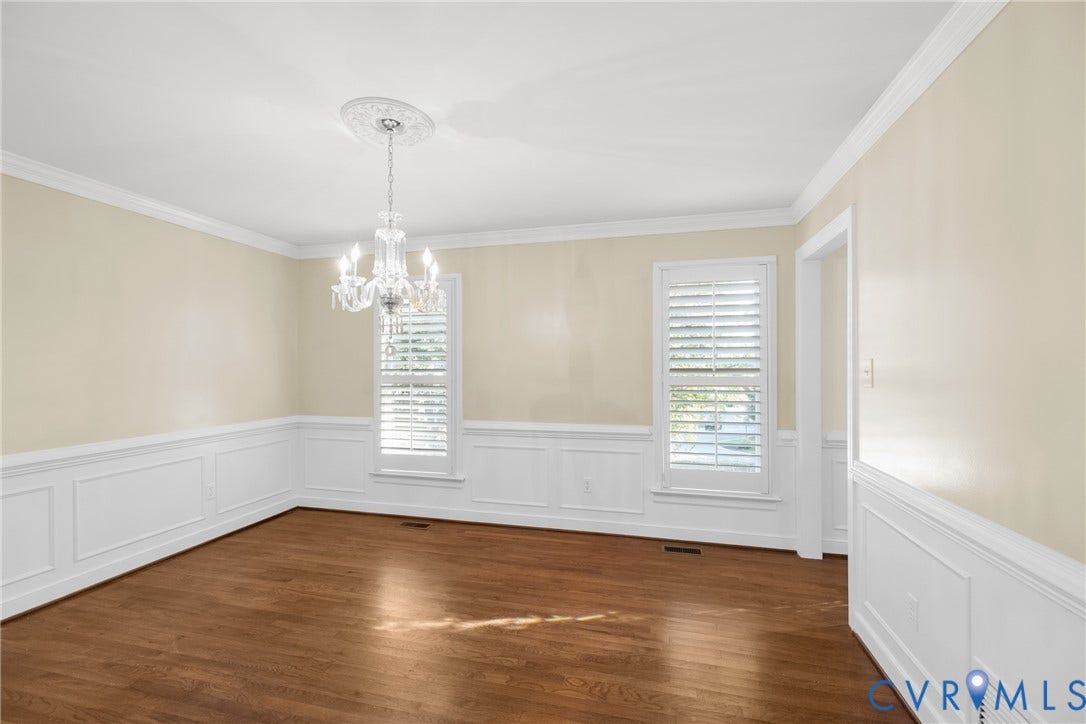 Plantation shutters and crown molding add classic character to the dining room.