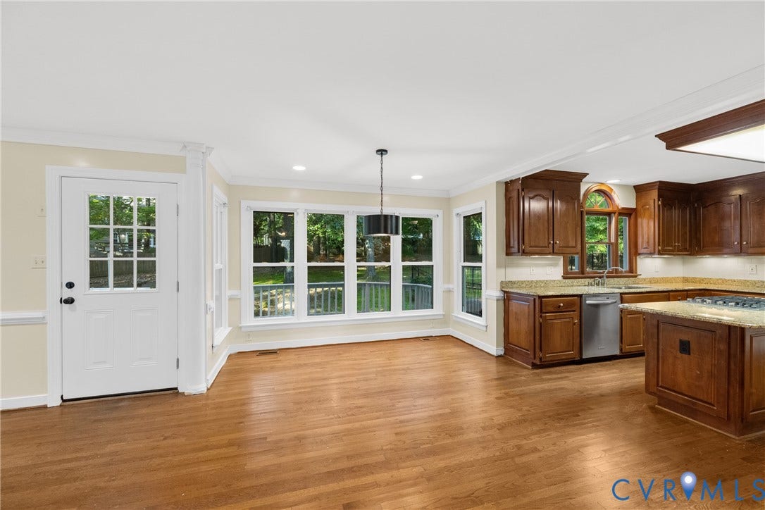 The oversized breakfast area, brightened by a bay window, is a welcoming spot for morning coffee and casual meals.