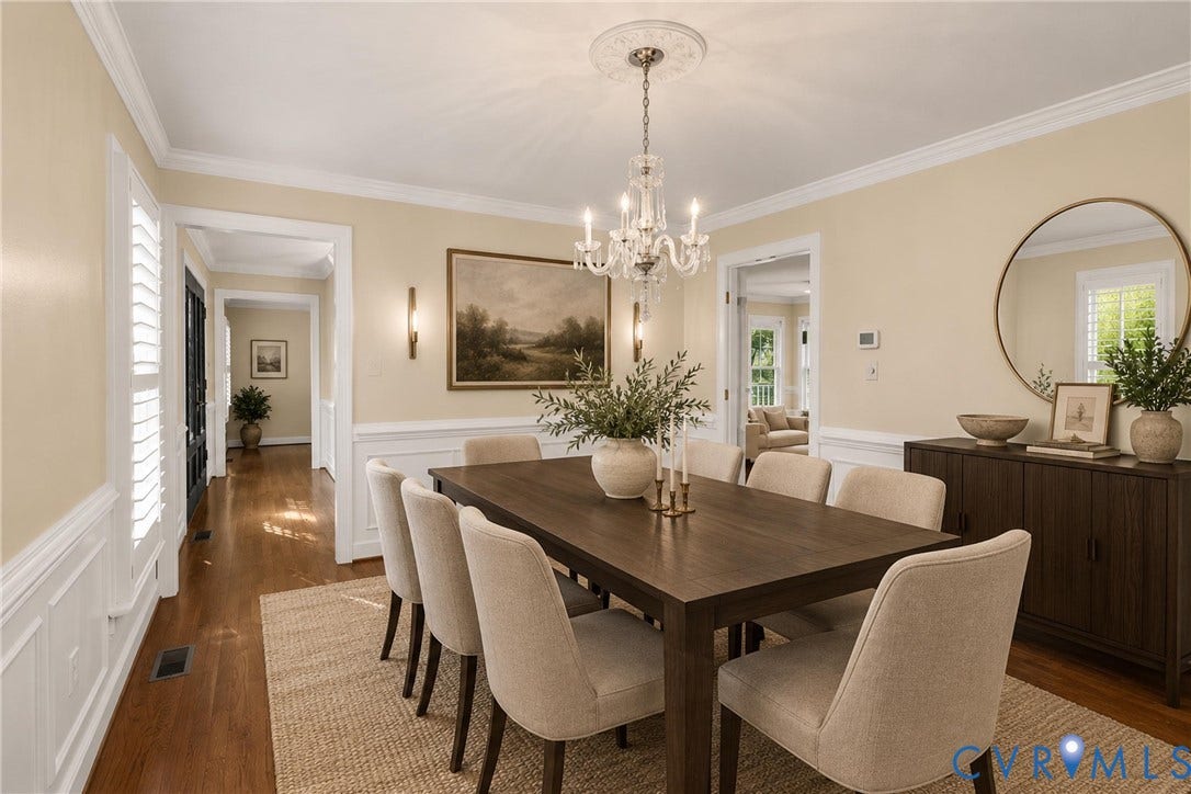 Virtually Staged: Wainscoting and a statement chandelier give the formal dining room refined, elegant style. *Photo is virtually staged*