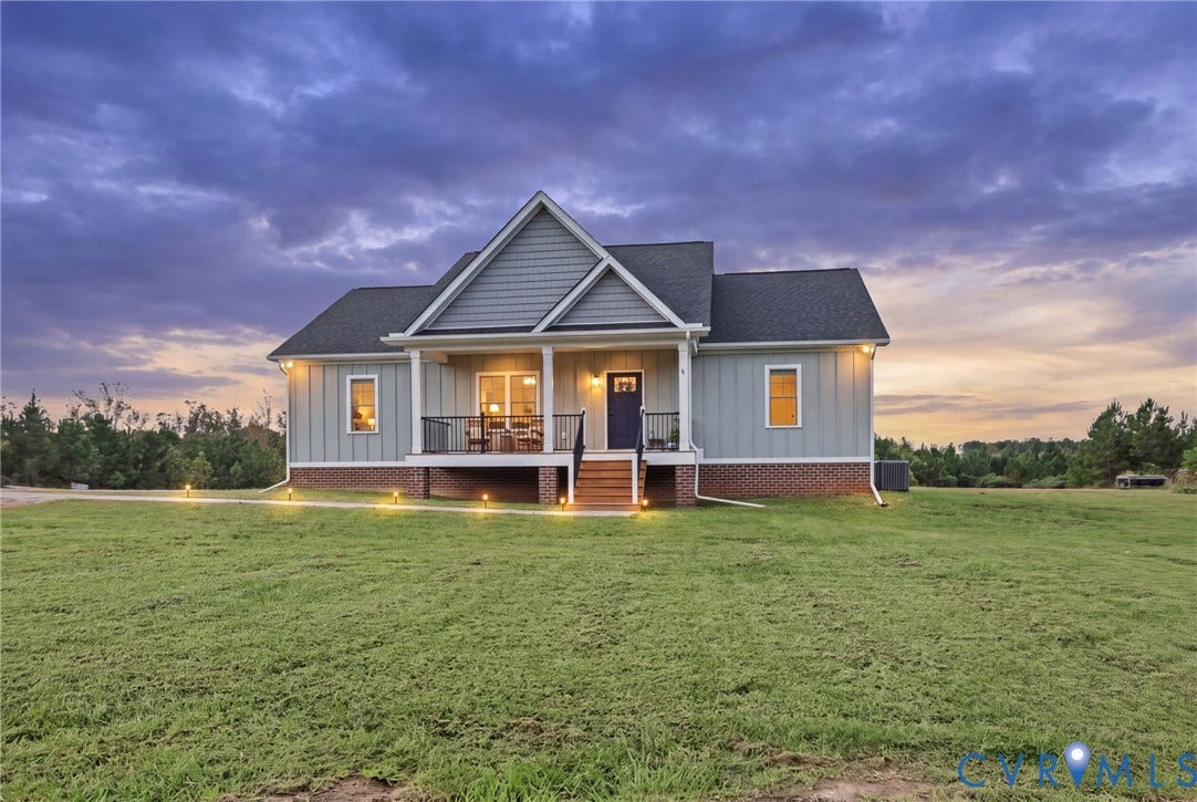 Ranch-style residence featuring light blue siding, a dark asphalt shingle roof, and a brick foundation