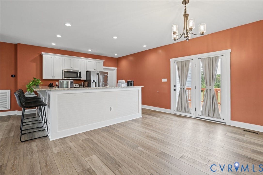 Kitchen featuring white cabinetry, light-toned wood-finish flooring, recessed lighting, a chandelier, and French doors