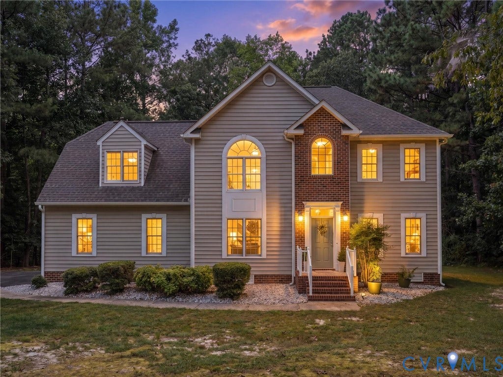 12000 Glen Kilchurn Drive, Chesterfield, VA 23838 Two-story residence featuring siding and brick accents, an arched window, dormer window, and a prominent front entrance with steps