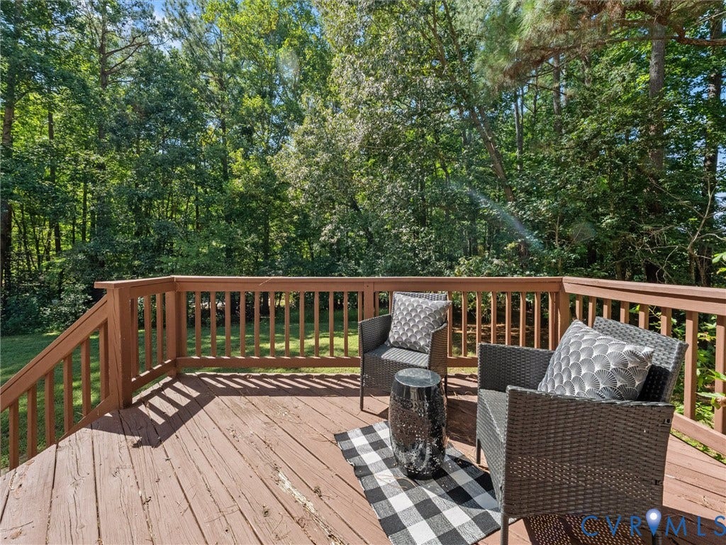 12000 Glen Kilchurn Drive, Chesterfield, VA 23838 Wood-finish deck with a built-in railing overlooking a dense tree line
