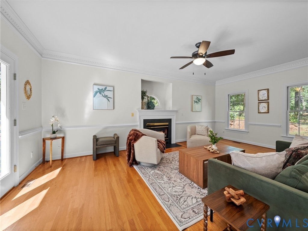 12000 Glen Kilchurn Drive, Chesterfield, VA 23838 Hardwood flooring, crown molding, fireplace with mantel, ceiling fan, and multiple windows