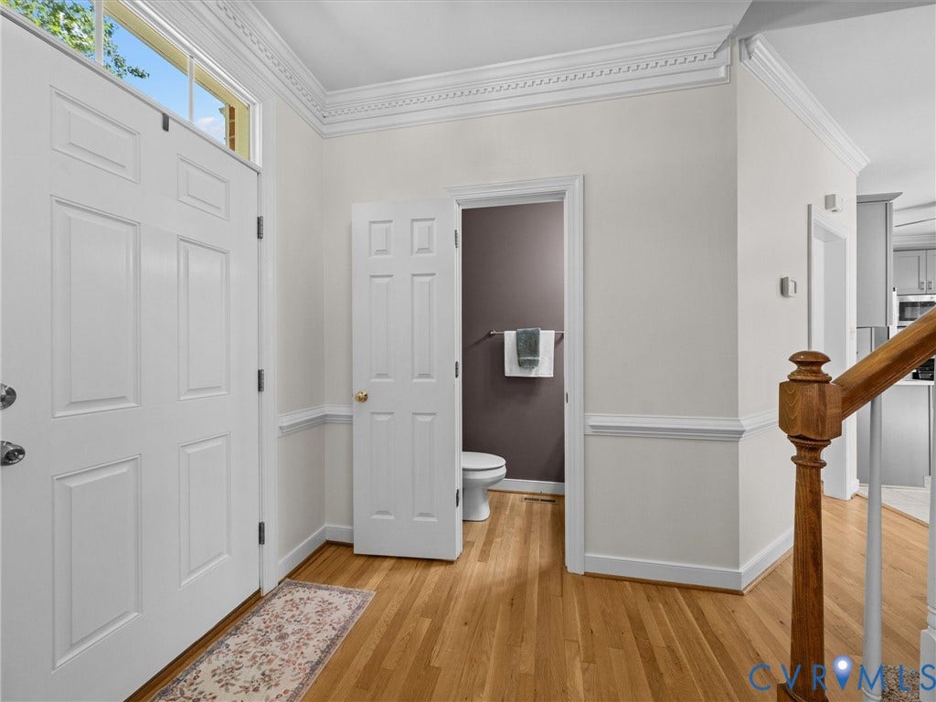 12000 Glen Kilchurn Drive, Chesterfield, VA 23838 Hardwood flooring, decorative crown molding, wainscoting, solid paneled interior door, and a wooden stair railing