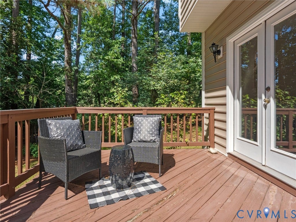 12000 Glen Kilchurn Drive, Chesterfield, VA 23838 Expansive wood deck with wood railings, double glass-paneled doors, and exterior wall siding