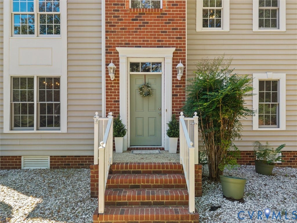 12000 Glen Kilchurn Drive, Chesterfield, VA 23838 Brick and siding exterior with a light green entry door, white trim, and white handrails