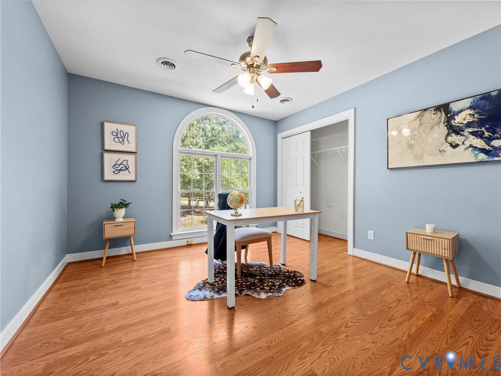 12000 Glen Kilchurn Drive, Chesterfield, VA 23838 Wood-finish flooring, an arched window, a ceiling fan, a built-in closet with bi-fold doors, and light blue wall paint