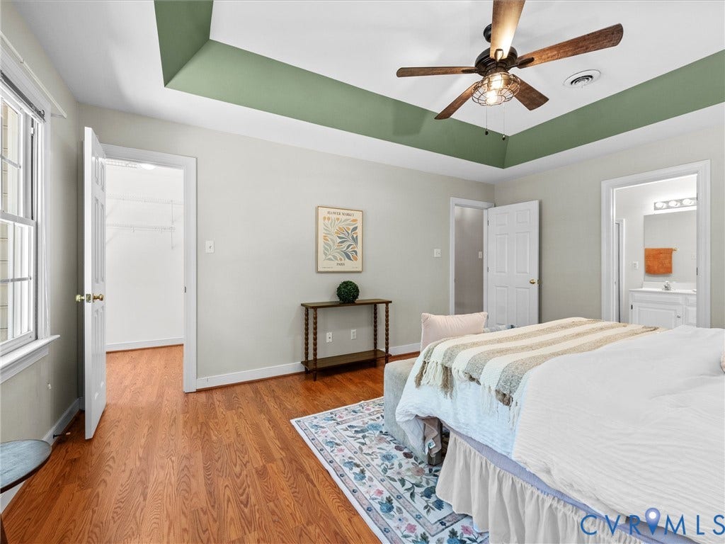 12000 Glen Kilchurn Drive, Chesterfield, VA 23838 Hardwood flooring throughout, tray ceiling with a ceiling fan, white paneled doors, and an en-suite bathroom with a vanity