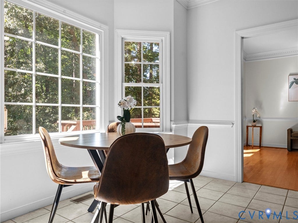 12000 Glen Kilchurn Drive, Chesterfield, VA 23838 White grid windows, light-toned tile flooring, white crown molding, and a doorway to a room with wood flooring