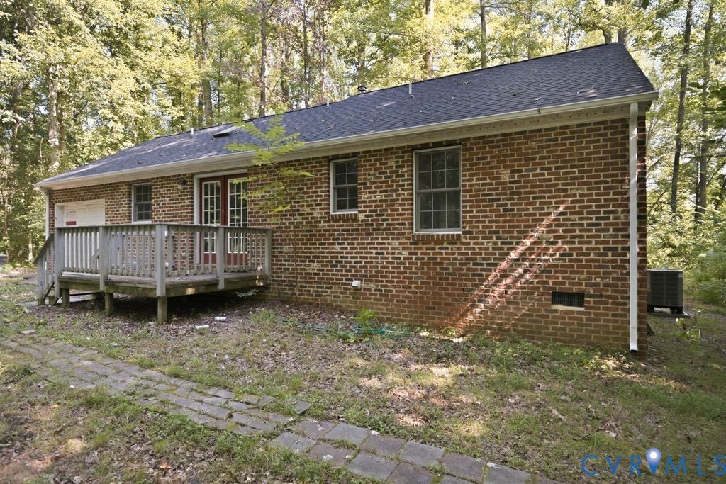 Brick exterior with a dark shingle roof and white gutters