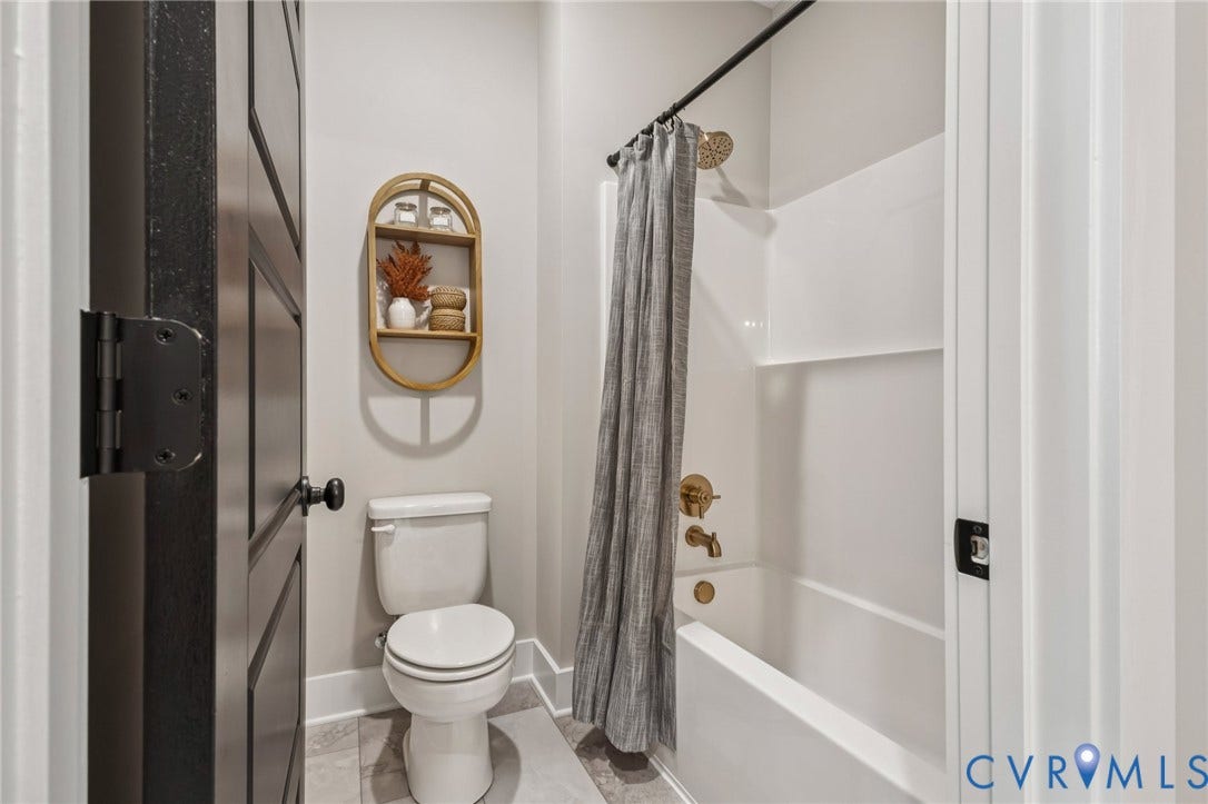 Lot 5 Olivet Church Road, Olivet Church Estates, New Kent, VA 23124 Bathtub and shower combination with brass-finish fixtures, white wall surround, and a coordinating dark rod