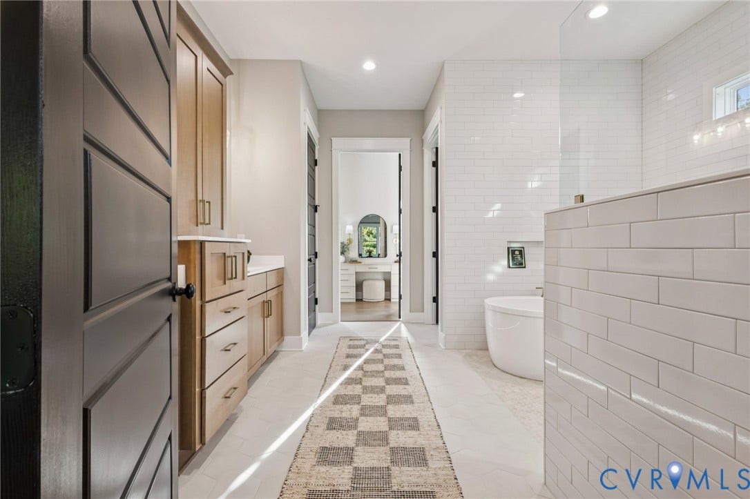 Lot 5 Olivet Church Road, Olivet Church Estates, New Kent, VA 23124 Built-in cabinetry with light-toned wood finish, white countertop, white subway tile shower surround, freestanding soaking tub, and recessed lighting