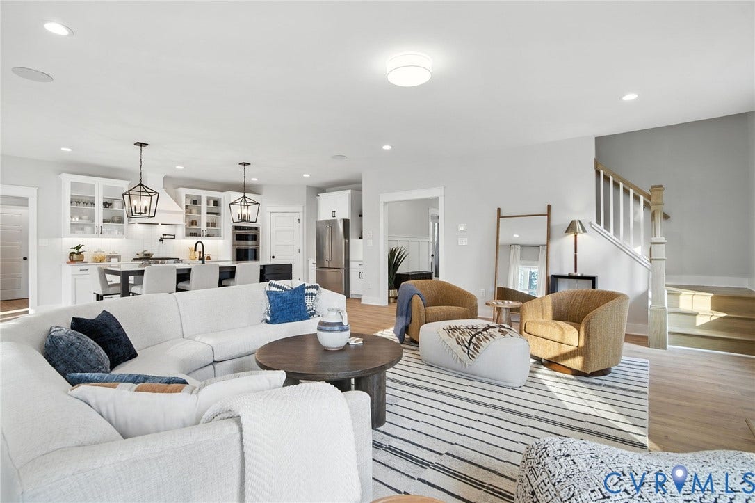 Lot 1 Needlewood Court, Olivet Church Estates, New Kent, VA 23124 Open-concept living area featuring light wood-finish flooring, recessed lighting, and a white wood staircase with natural wood railings