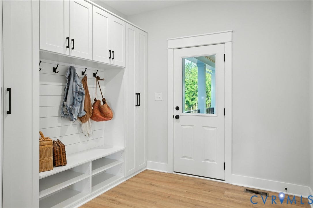 Lot 1 Needlewood Court, Olivet Church Estates, New Kent, VA 23124 Built-in white cabinetry with black hardware, integrated bench seating, and wood-finish flooring