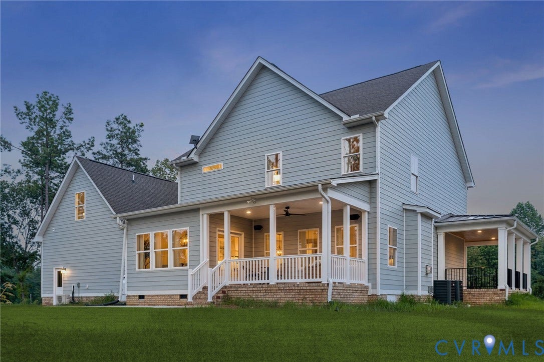 Lot 1 Needlewood Court, Olivet Church Estates, New Kent, VA 23124 Rear exterior featuring light blue siding, a covered porch with white railing, an additional covered patio, multiple windows, and a grass lawn