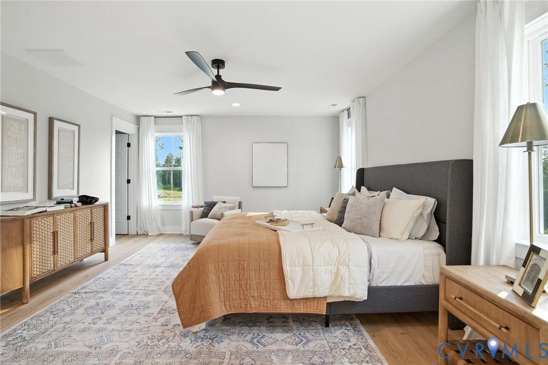 Lot 1 Needlewood Court, Olivet Church Estates, New Kent, VA 23124 Bright room featuring wood-finish flooring, multiple windows, a ceiling fan, and a built-in closet with a dark-paneled door