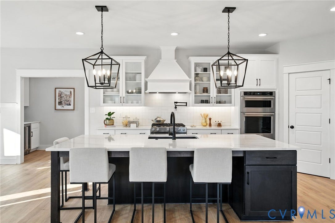 Lot 1 Needlewood Court, Olivet Church Estates, New Kent, VA 23124 Spacious kitchen featuring an expansive island with seating, white shaker cabinetry, stainless steel double wall ovens, and wood-finish flooring