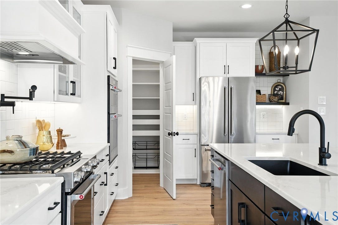 Lot 1 Needlewood Court, Olivet Church Estates, New Kent, VA 23124 Gourmet kitchen featuring stainless steel appliances, a gas range with range hood, double wall ovens, a walk-in pantry, and an island with an undermount sink